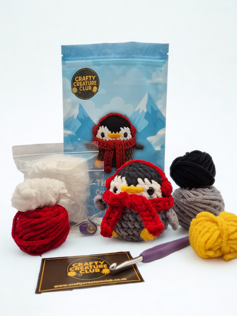 Full contents of the Iggy penguin crochet kit including plush yarn, pattern and accessories