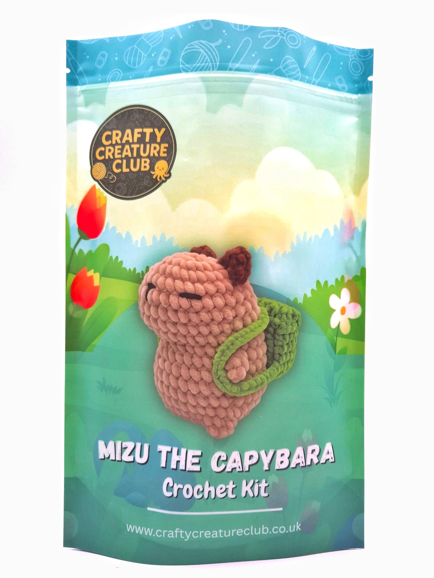 Crochet kit packaging for Mizu the Capybara with a scenic background and 'Crafty Creature Club' branding.