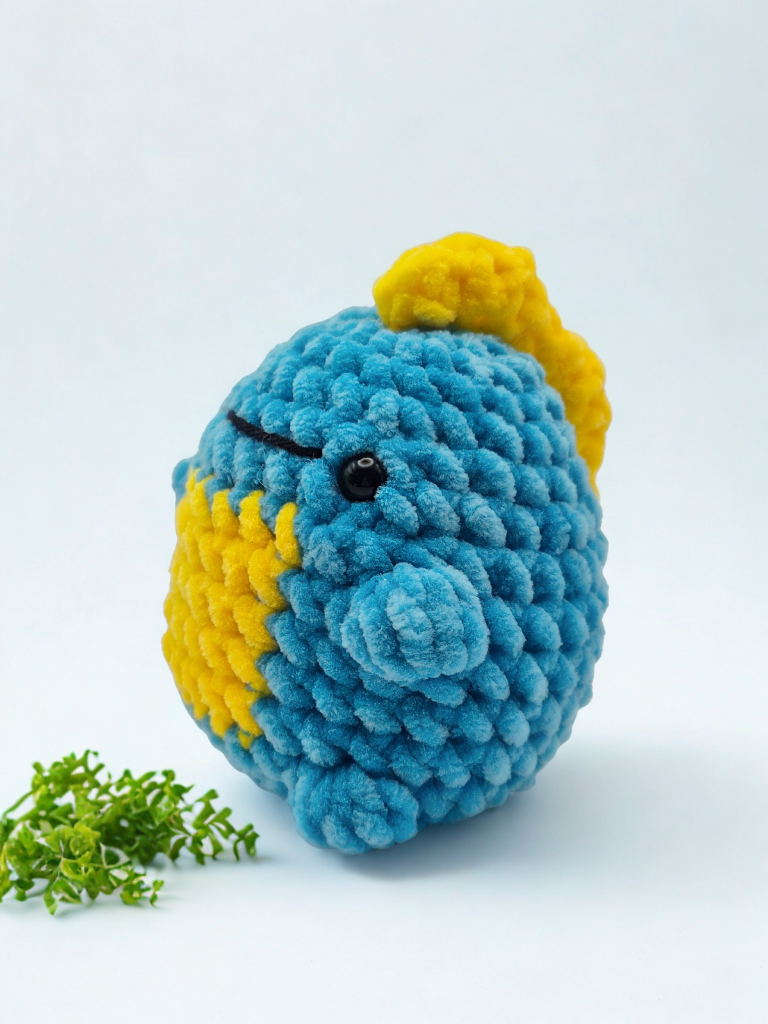 Close-up of Rory the dinosaur amigurumi made using plush chenille yarn