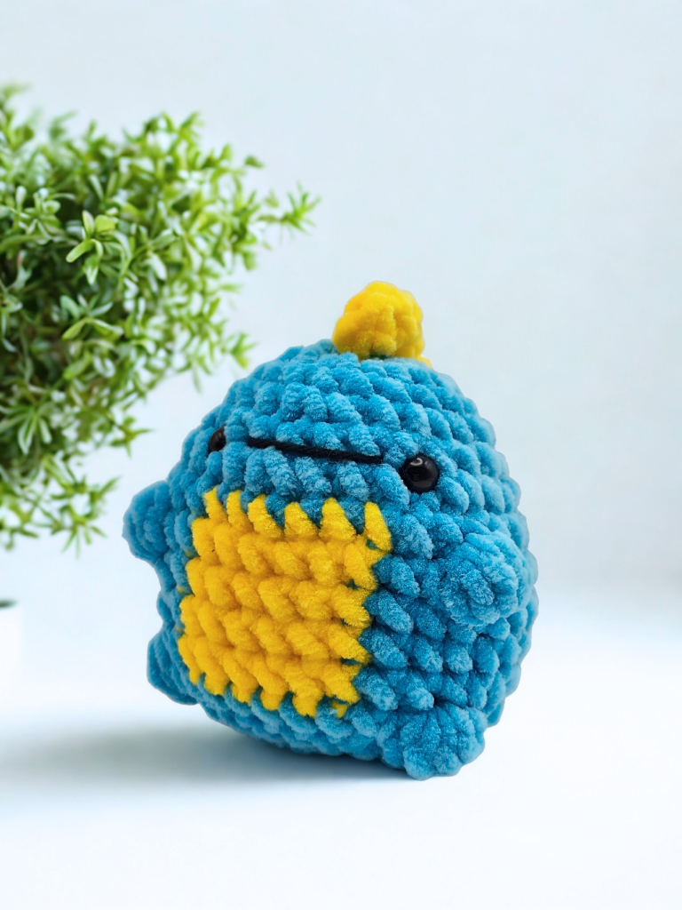 Finished Rory dinosaur crochet kit toy in blue plush chenille yarn with yellow tummy and spikes
