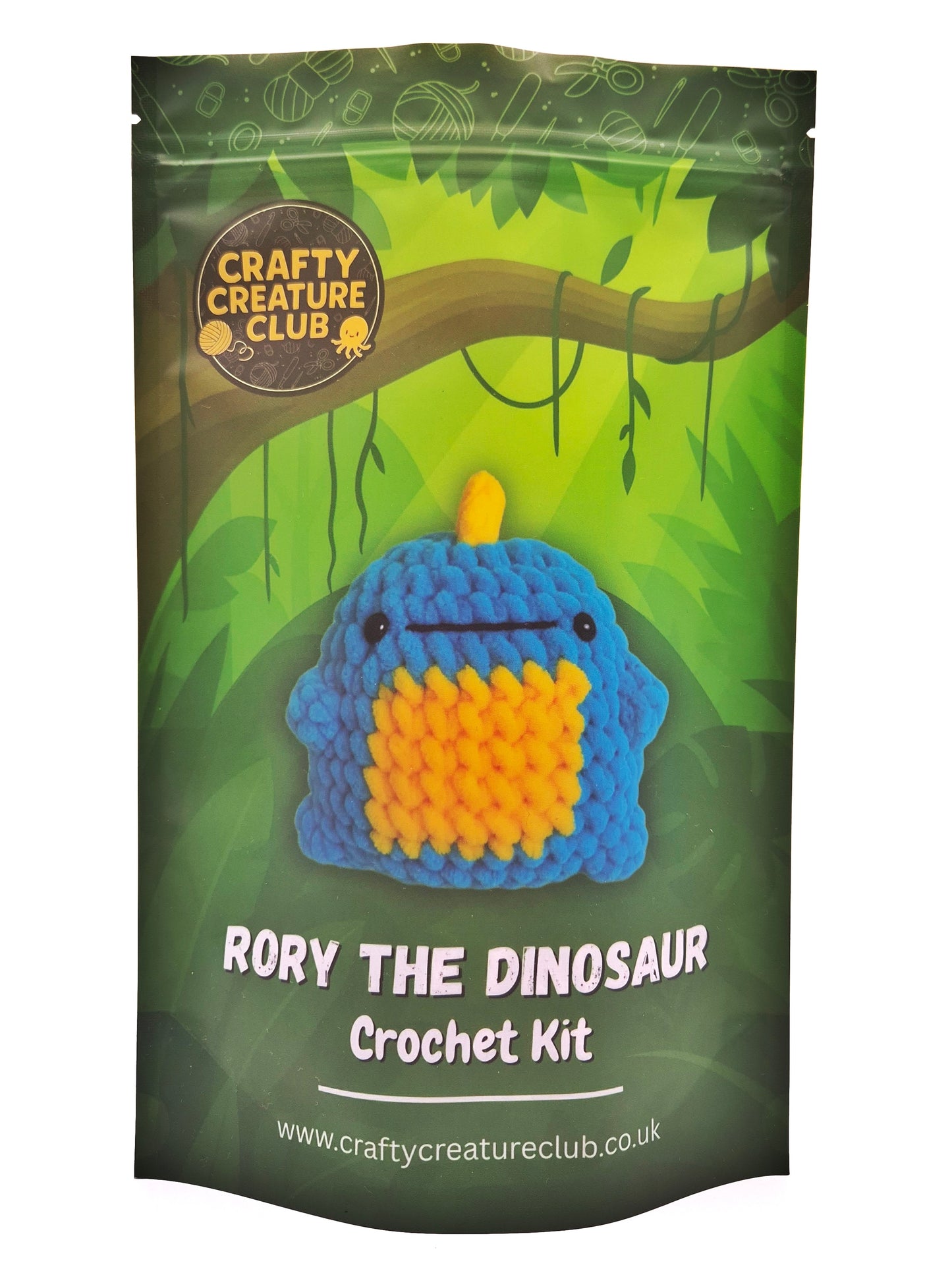 Crochet kit packaging for 'Rory the Dinosaur' with Crafty Creature Club branding.