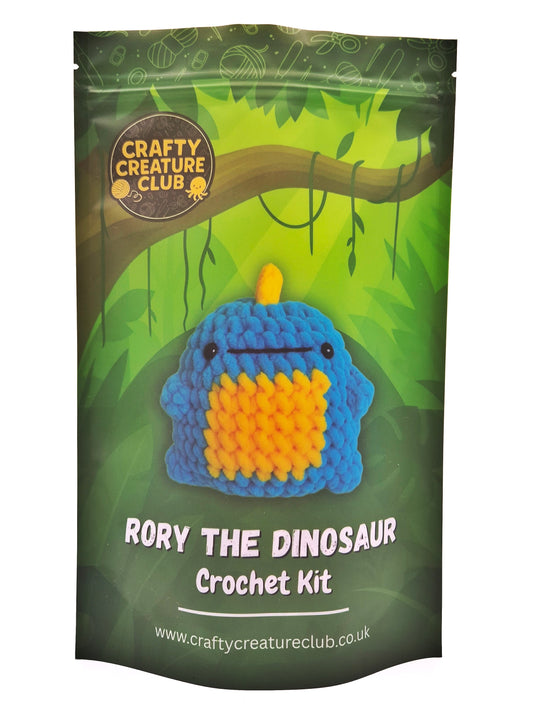 Crochet kit packaging for 'Rory the Dinosaur' with Crafty Creature Club branding.